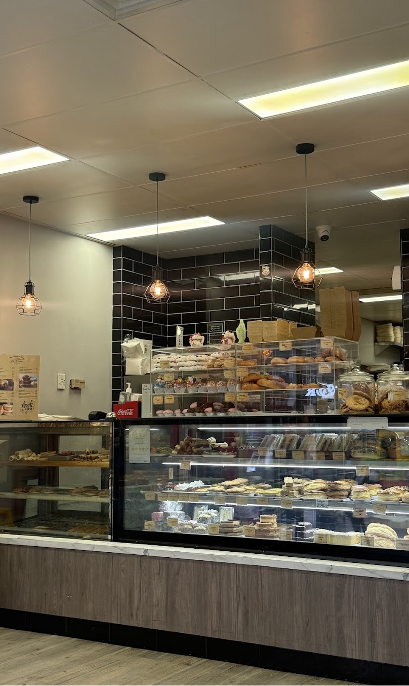 Bakery display cabinet full of Boulangerie Vietnam pastries and cakes